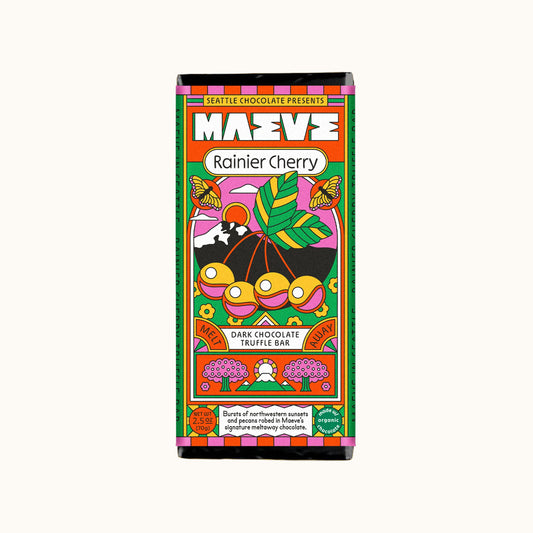 Colorful packaging of a Rainier Cherry dark chocolate truffle bar by MAEVE on a white background