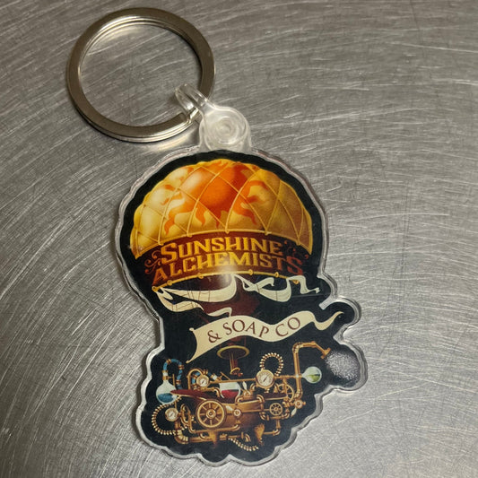 Keychain of a steampunk hot air balloon with bathtub alchemical laboratory