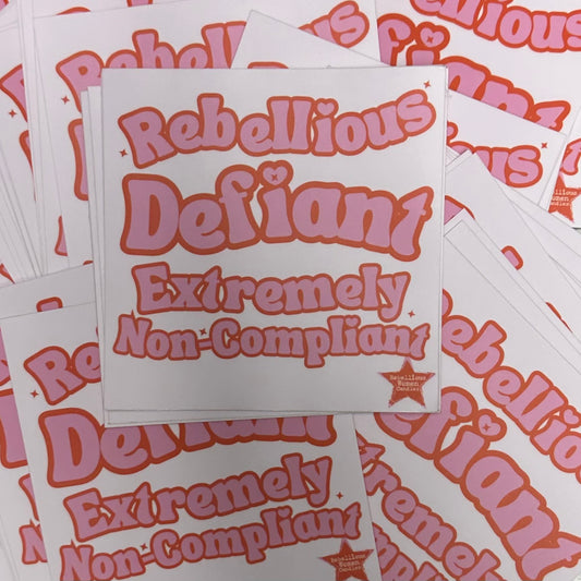 Stack of stickers with text 'Rebellious Defiant Extremely Non-Compliant' on a matching background.